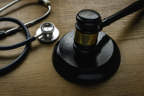 Law in healthcare and medical. Medical malpractice, personal injury law.Judgement of common mistakes made by nurses,doctors or hospital. Gavel and stethoscope.