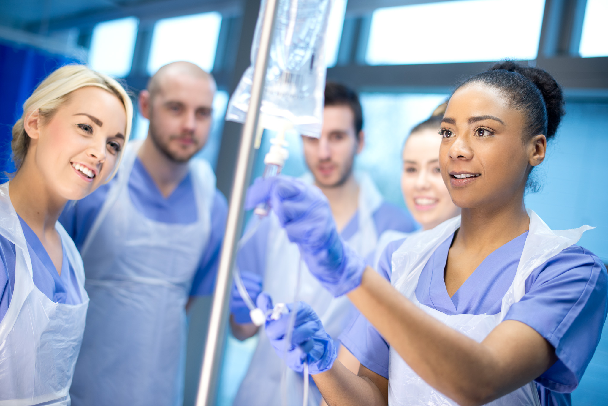 nurse shows other trainees how to use the IV drip