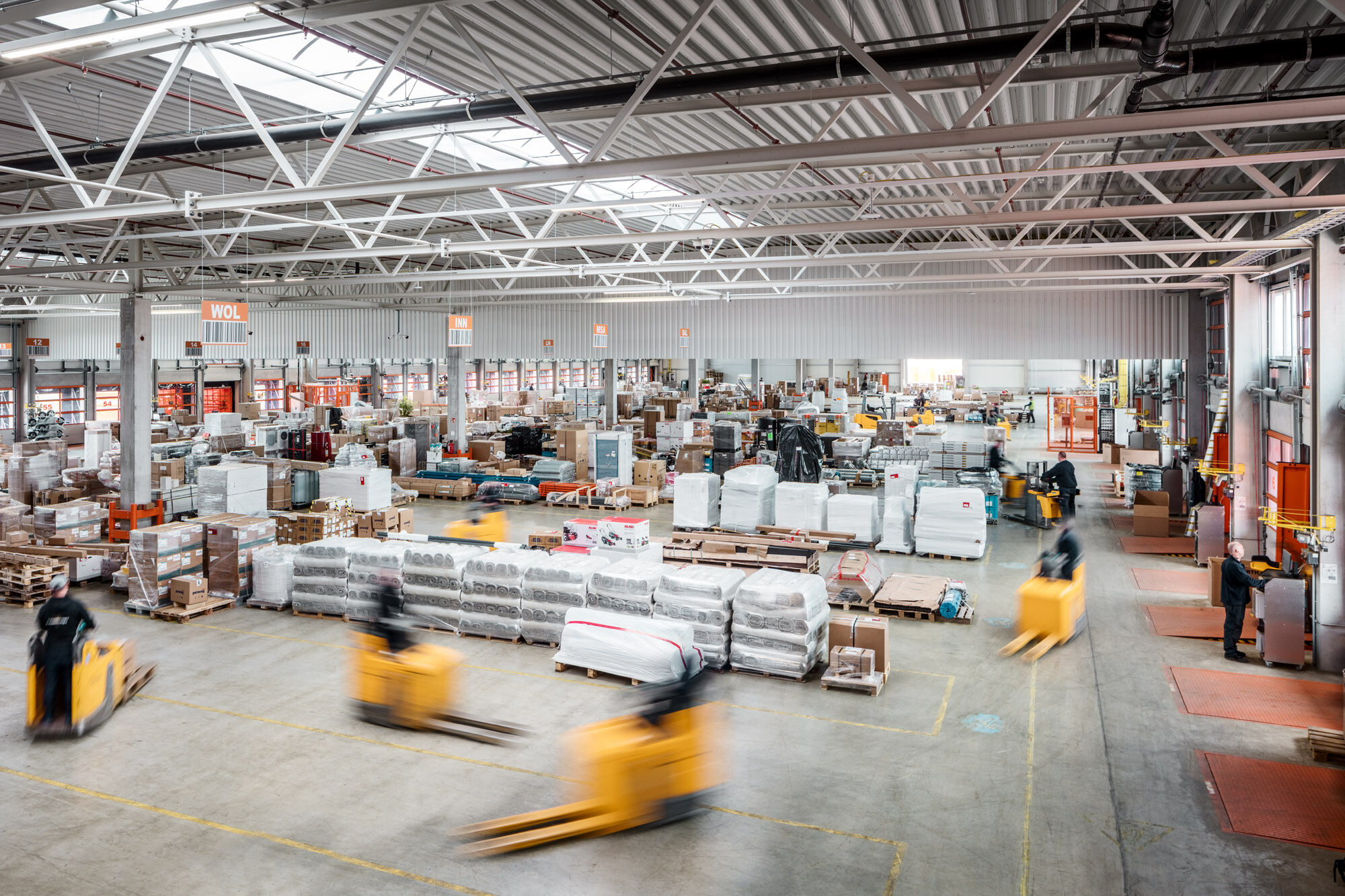 Warehouse operations with forklifts moving palletized freight through a distribution facility.
