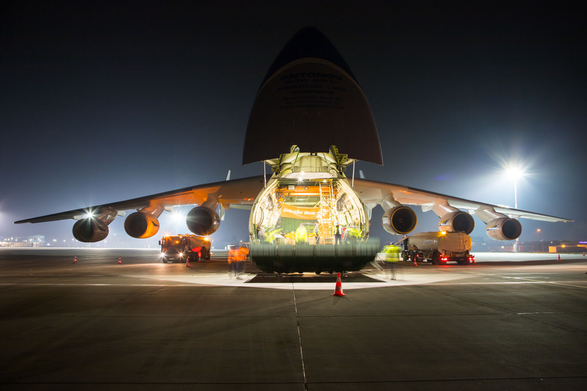 Cargo is loaded onto a large aircraft at night, representing reliable air freight logistics for time-sensitive global shipments.