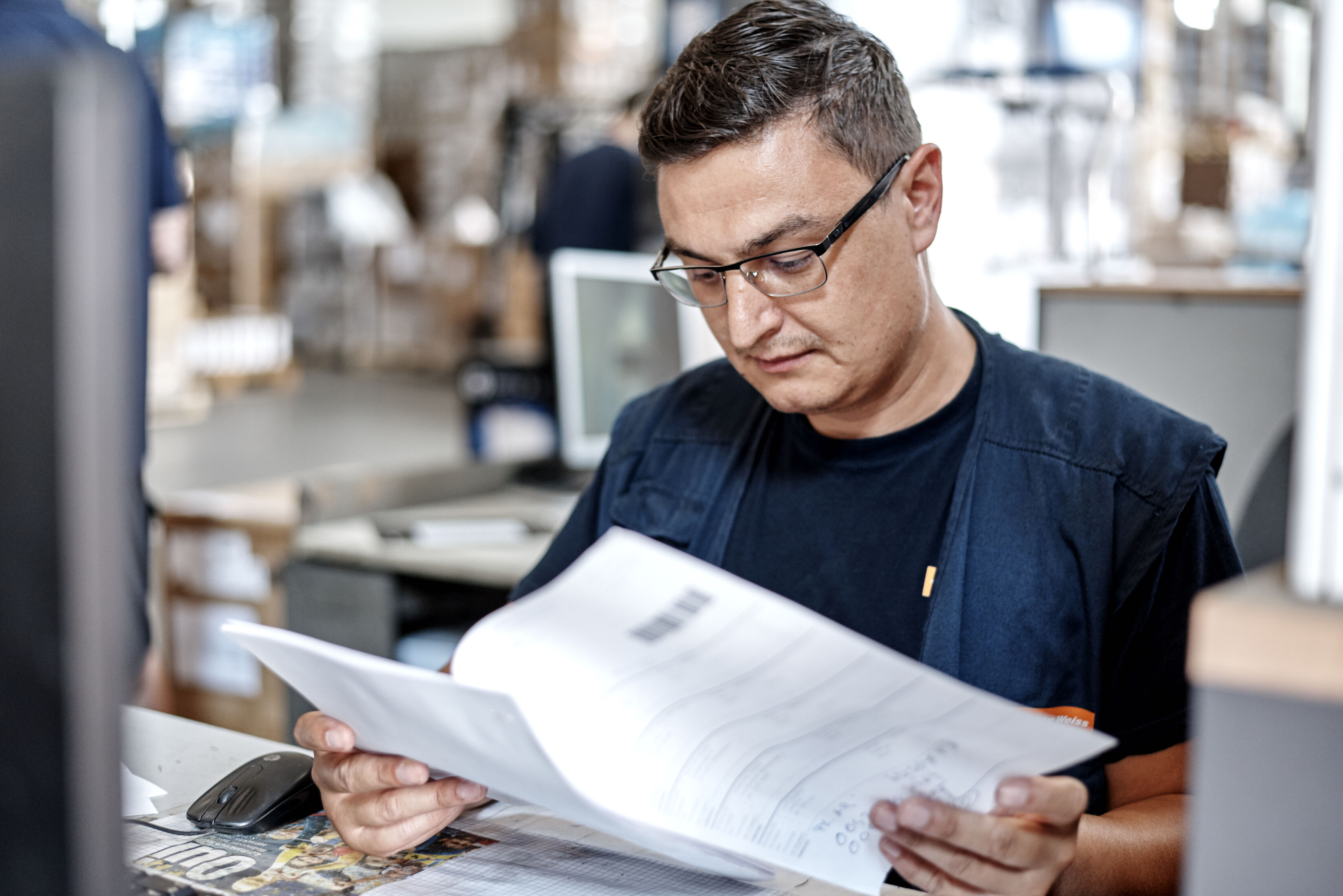 Logistics professional reviewing shipping documents for a cross-border freight shipment.
