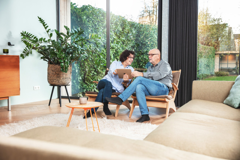 Couple using tablet in living room