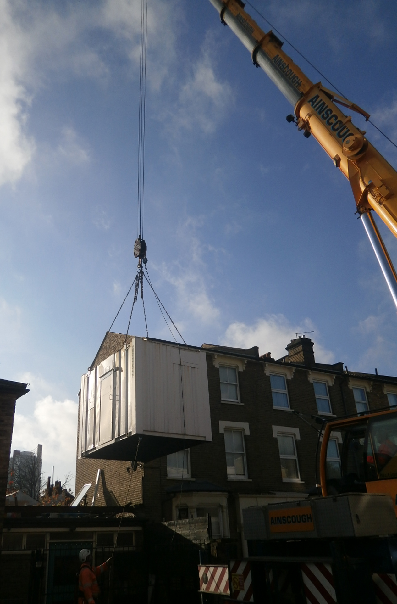 Crane used to remove illegal shipping container from property roof